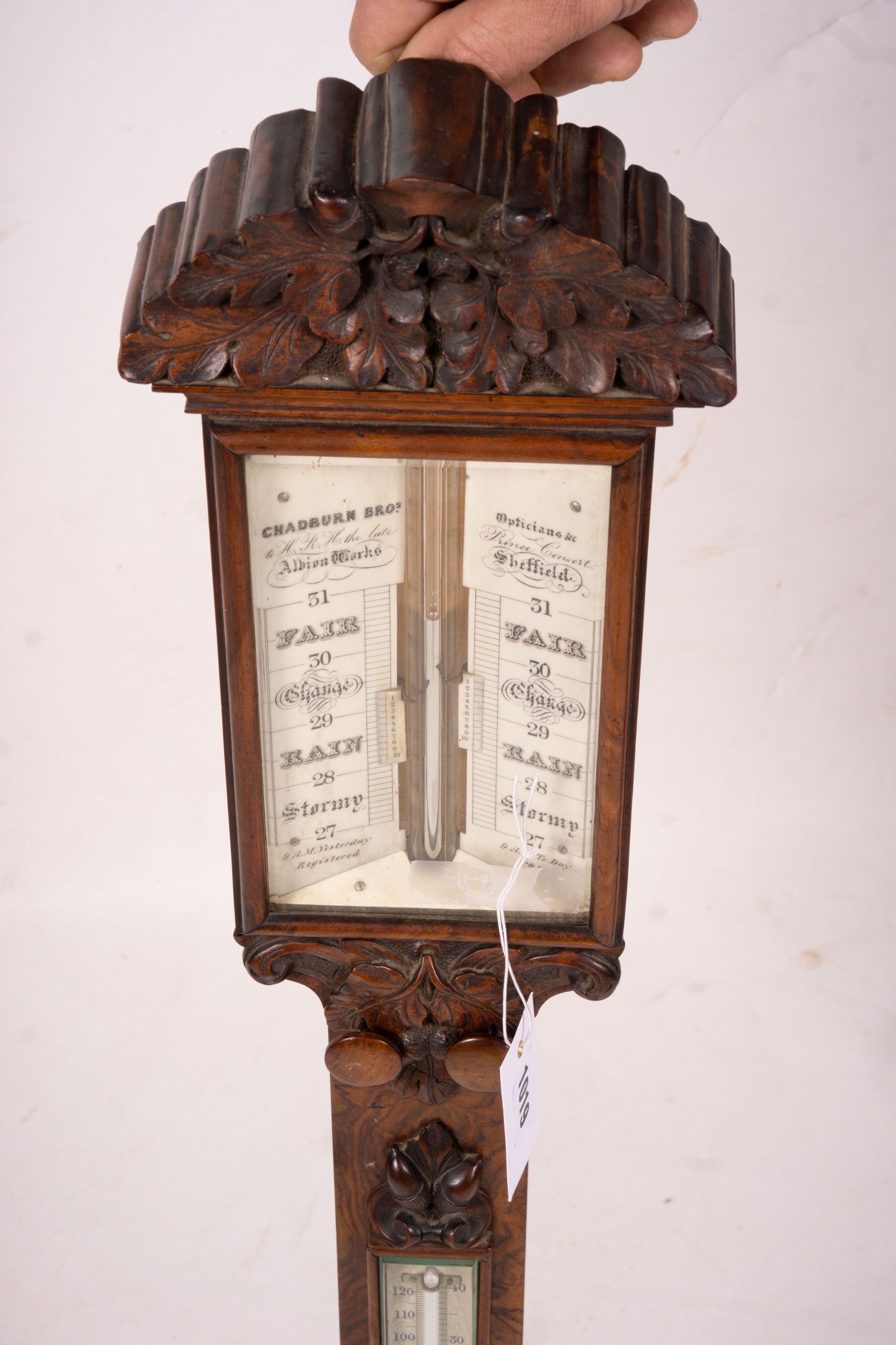 A Victorian carved walnut stick barometer by Chadburn Bros., Sheffield, height 104cm